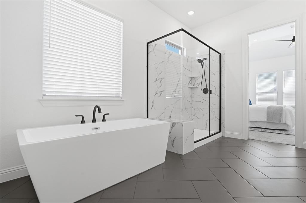 513 Fieldstone Lane Haslet, TX 76052 - Photo 23 of 39 a bathroom with a bathtub and a shower
