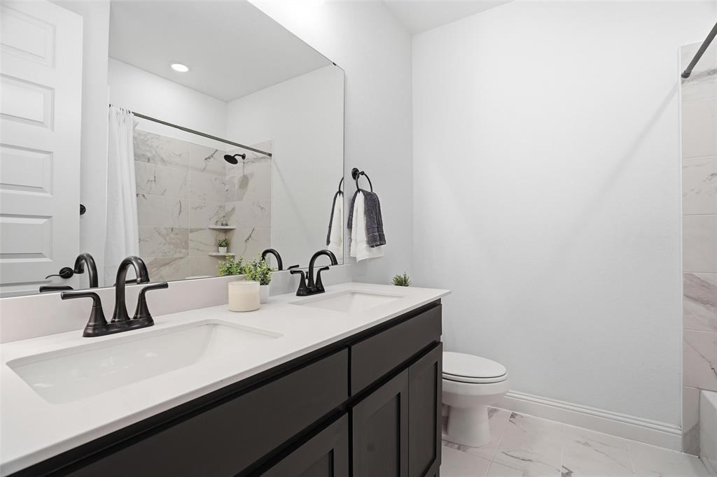 513 Fieldstone Lane Haslet, TX 76052 - Photo 26 of 39 a bathroom with a sink a toilet and mirror
