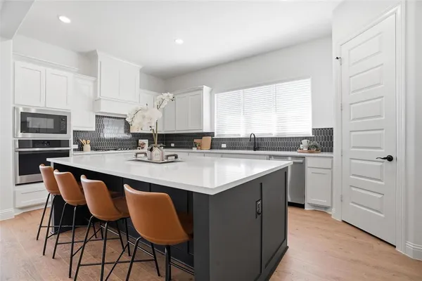 a kitchen with stainless steel appliances granite countertop a sink and cabinets