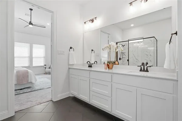 a bathroom with a double vanity sink and mirror