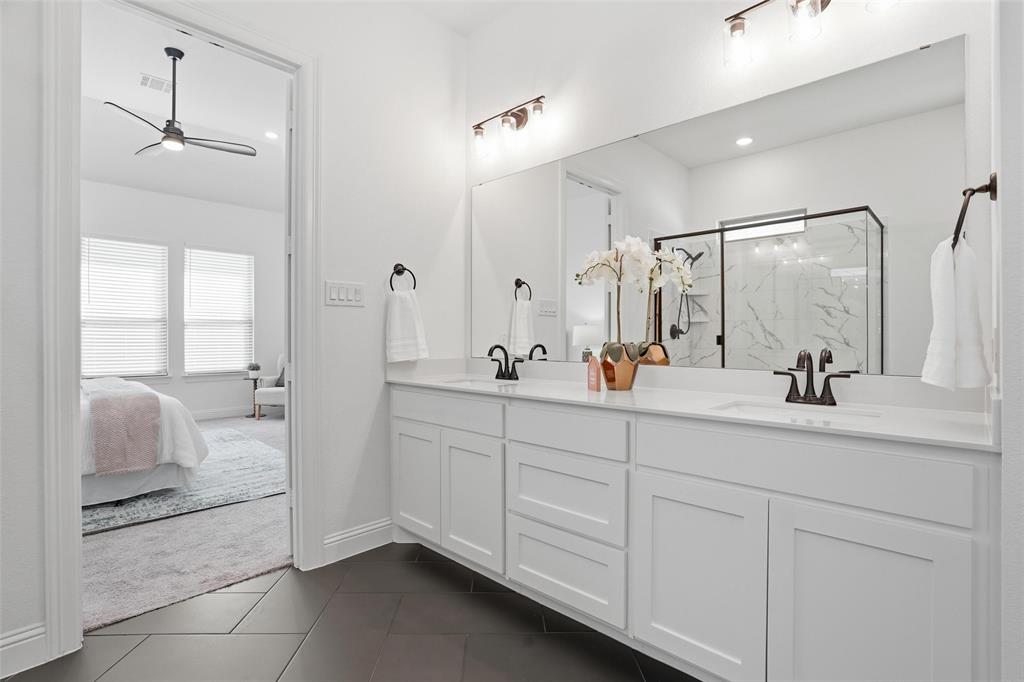 513 Fieldstone Lane Haslet, TX 76052 - Photo 7 of 39 a bathroom with a double vanity sink and mirror