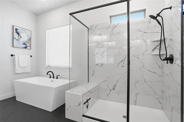 a bathroom with a bathtub and shower