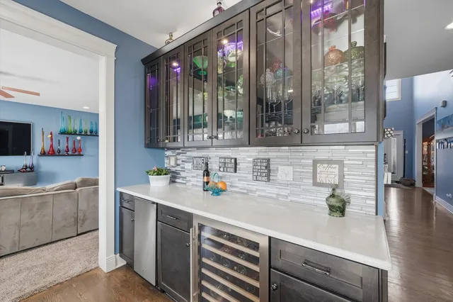 a kitchen with a sink a counter top space and living room filled with furniture