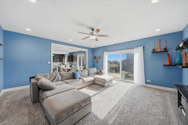 a living room with furniture ceiling fan and a rug