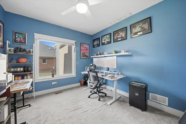 a view of a workspace with furniture and a window