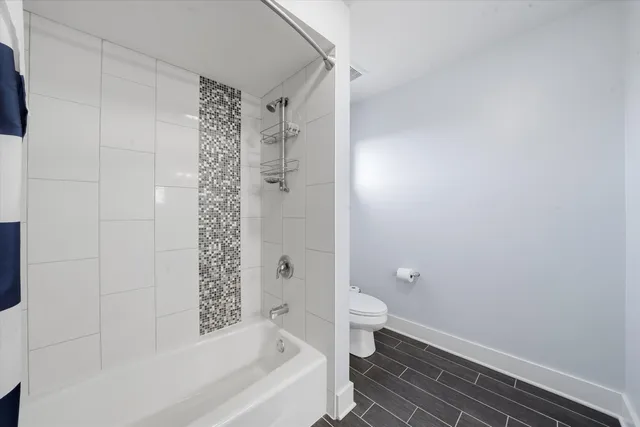 a bathroom with a bathtub and shower