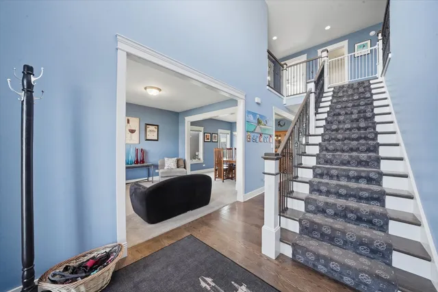 a view of a living room with furniture and wooden floor