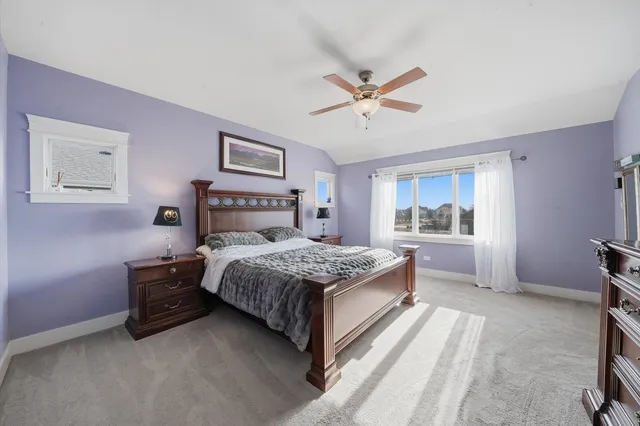 a bedroom with a large bed and a chandelier