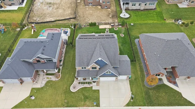 an aerial view of a house with a swimming pool