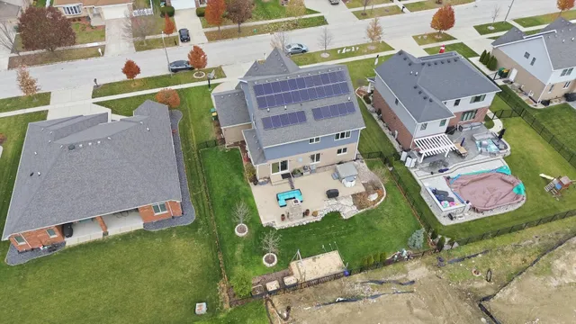 an aerial view of a house with a yard