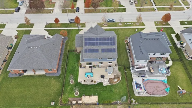 an aerial view of a house with outdoor space pool seating area and fire pit