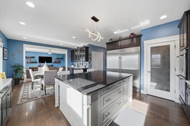 a kitchen with stainless steel appliances granite countertop a sink and a refrigerator