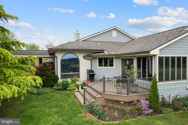 a front view of house with a garden and patio