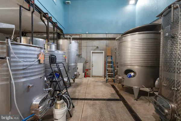 a front view of a house with a yard and potted plants