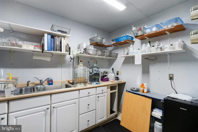 a view of a lake with a floor to ceiling window next to a yard