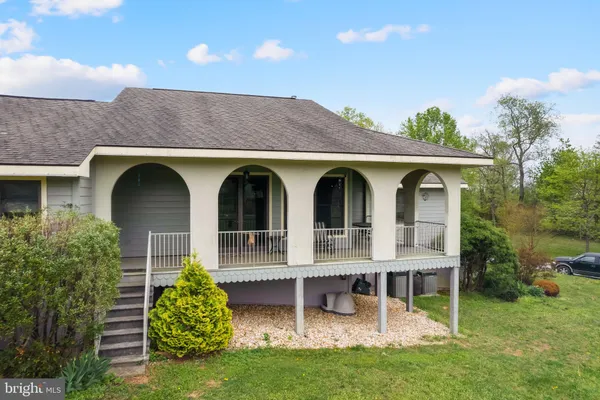a view of a house with porch and garden