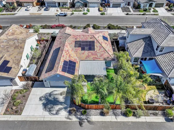 a view of an empty room with a chandelier fan