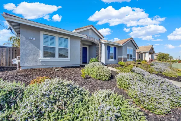a large kitchen with kitchen island a stove a sink a center island and stainless steel appliances