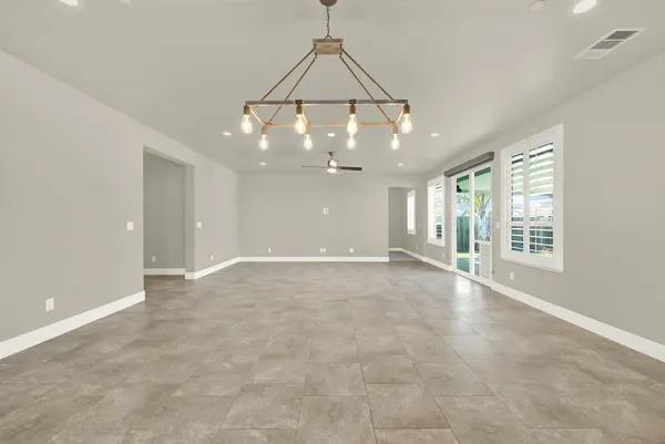 a view of a livingroom with a ceiling fan and window