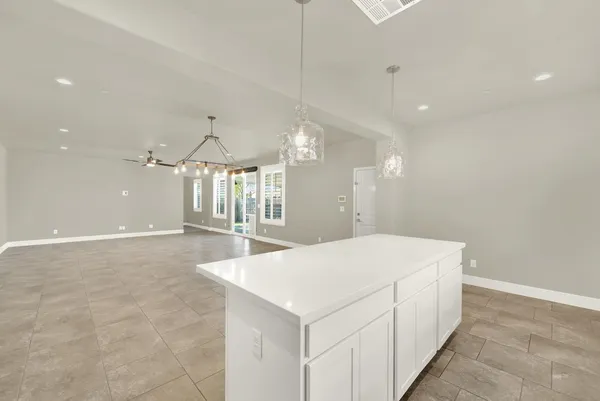 a view of a house with a yard and potted plants