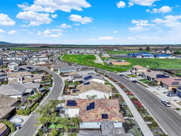 a front view of a multi story residential apartment building with a yard