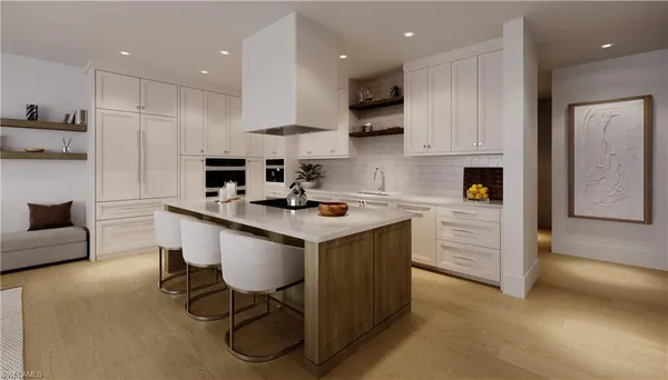 a kitchen that has a lot of cabinets in it and appliances