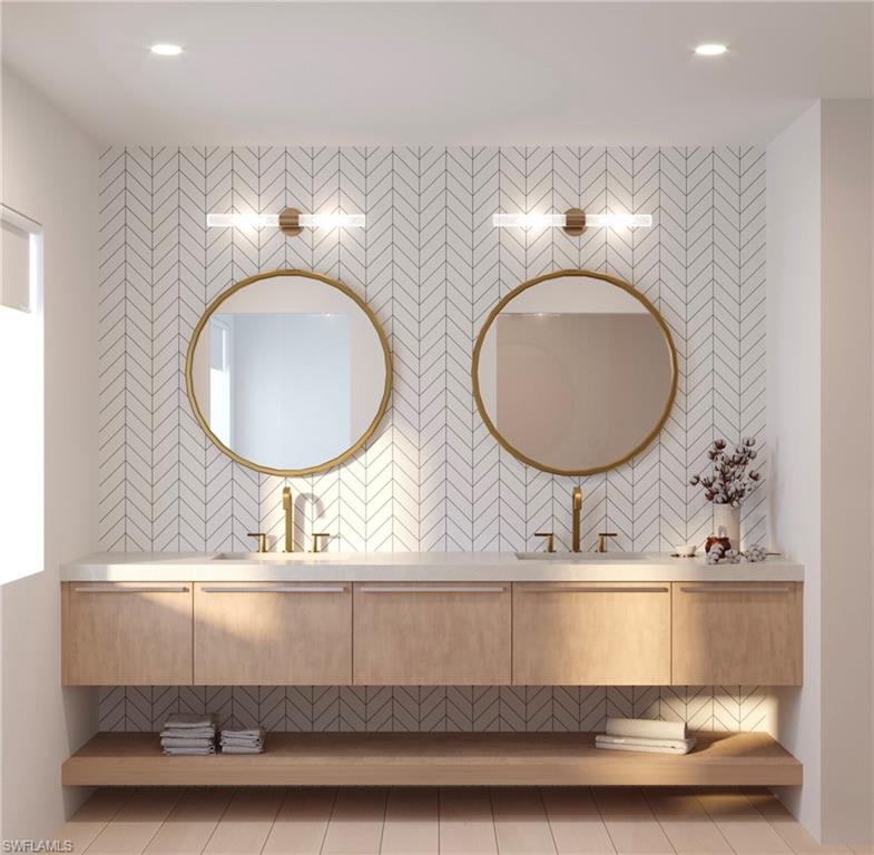 180 9th Street South, Unit 201 Naples, FL 34102 - Photo 2 of 5 a bathroom with a sink and a mirror