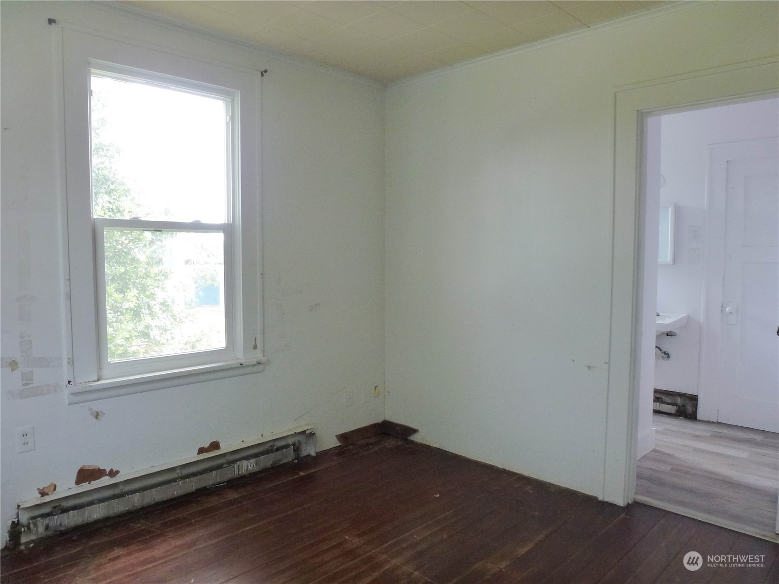 17096 Fir Island Road Mount Vernon, WA 98273 - Photo 14 of 22 an empty room with wooden floor and windows