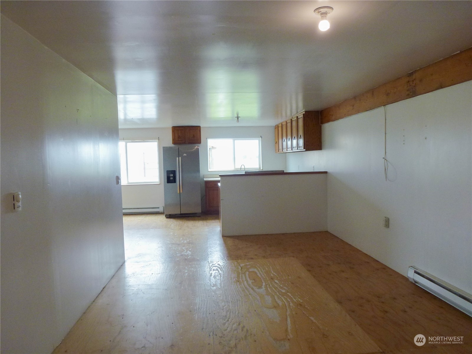 17096 Fir Island Road Mount Vernon, WA 98273 - Photo 17 of 22 an empty room with wooden floor and windows