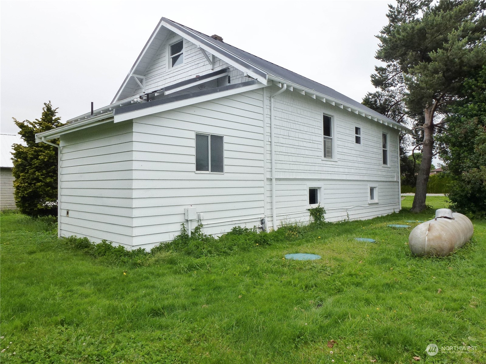 17096 Fir Island Road Mount Vernon, WA 98273 - Photo 2 of 22 a front view of a house with a garden
