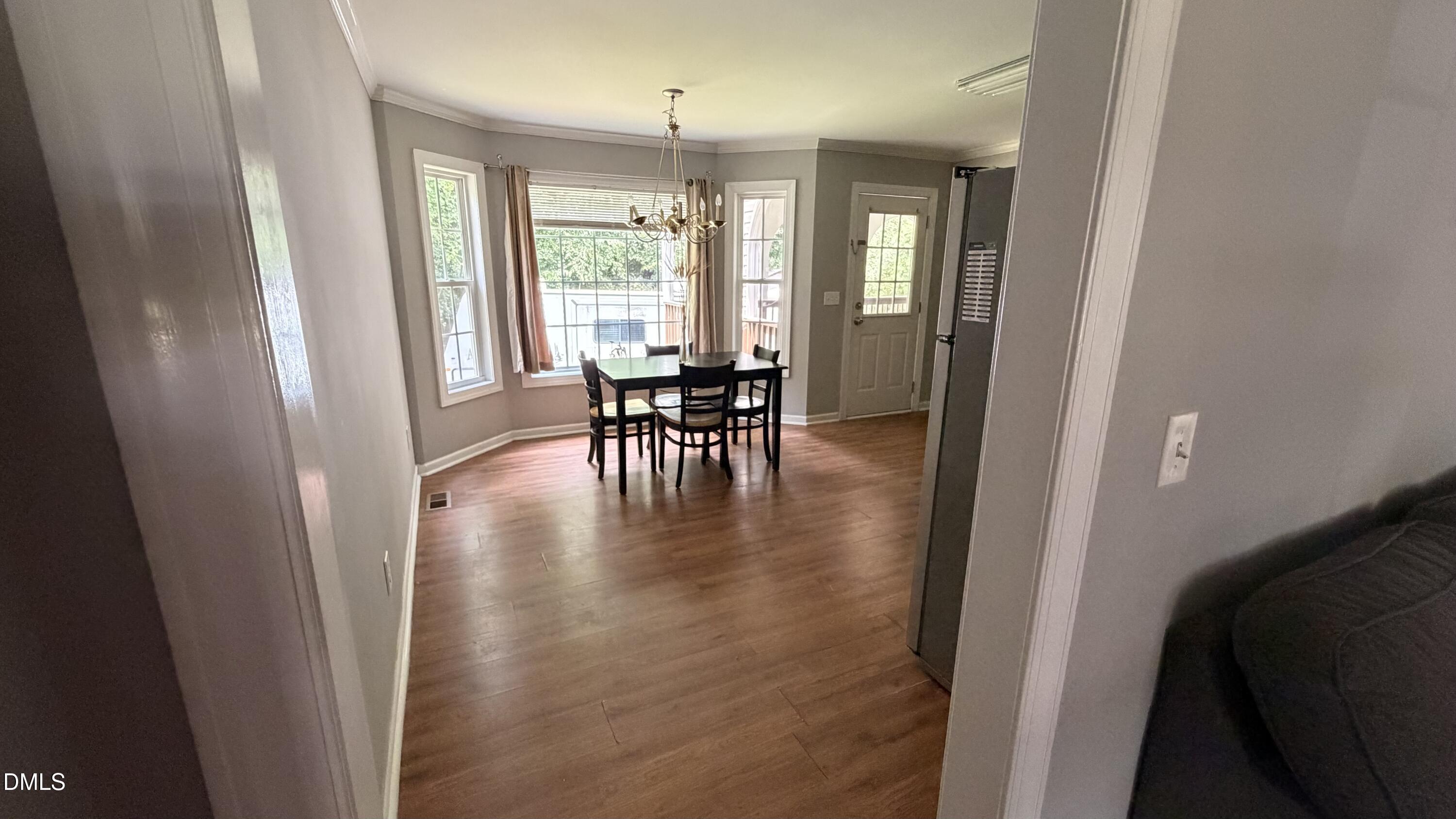 229 Sterling Way Angier, NC 27501 - Photo 8 of 10 a view of a dining room with furniture and a chandelier