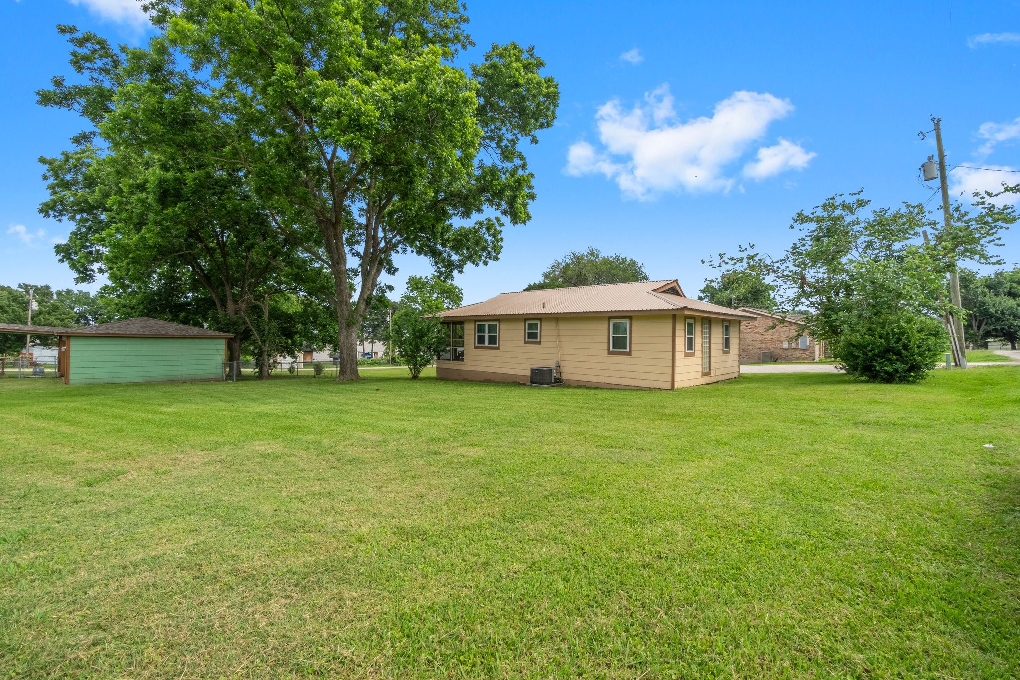 21 Clearview Point Blank, TX 77364 - Photo 41 of 43 a white house with a big yard and large trees