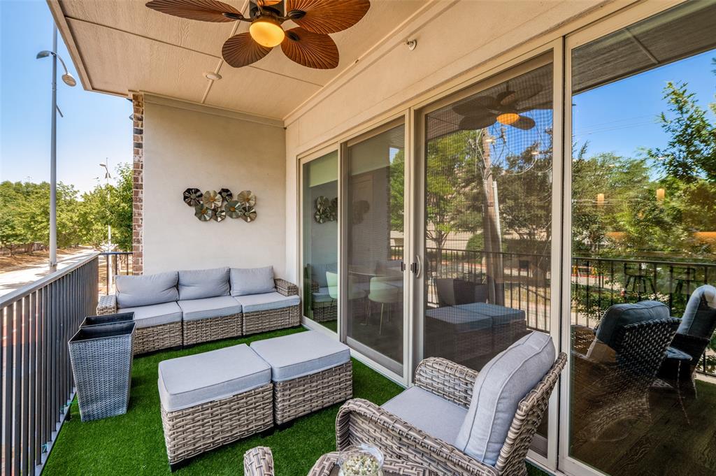 15875 Spectrum Drive, Unit 1101 Addison, TX 75001 - Photo 26 of 37 A wall of sliding glass doors opens to the covered terrace with ceiling fan and turf cover