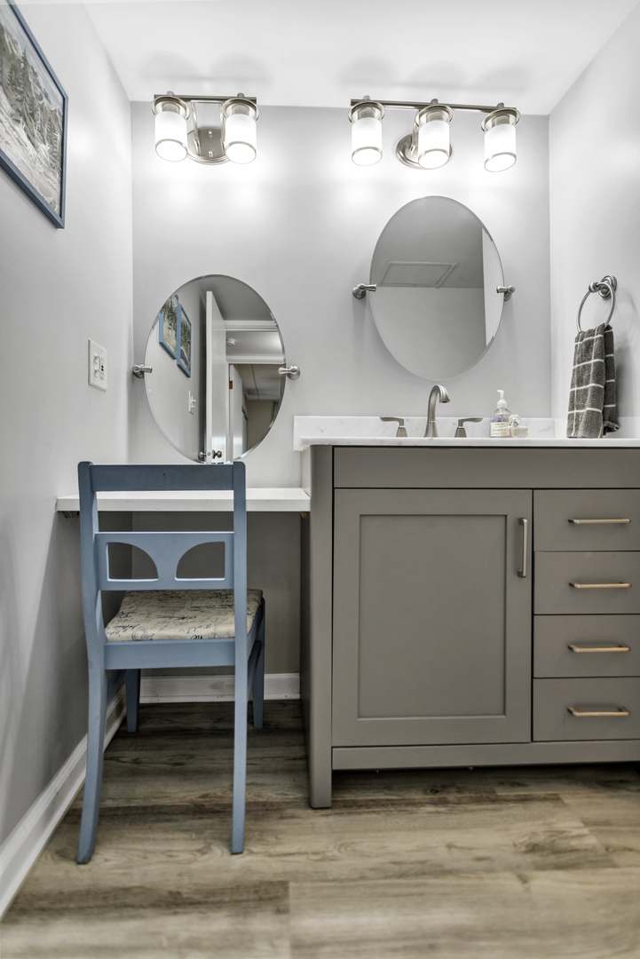 110 West Butterfield Road, Unit 507S Elmhurst, IL 60126 - Photo 8 of 12 a room with a mirror and a wooden floor
