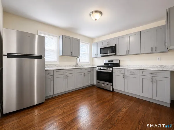 a kitchen with wooden cabinets and white appliances