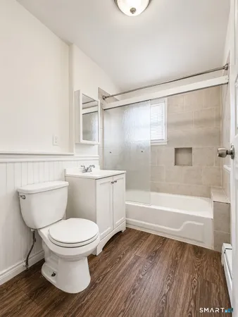 a white toilet sitting next to a bathroom sink