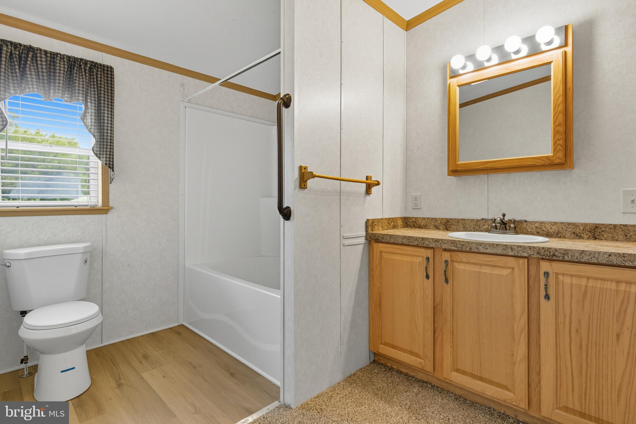 800 York Road, Unit 290 Dover, PA 17315 - Photo 21 of 23 a bathroom with a granite countertop sink toilet and shower
