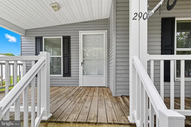 a view of balcony with wooden floor and fence