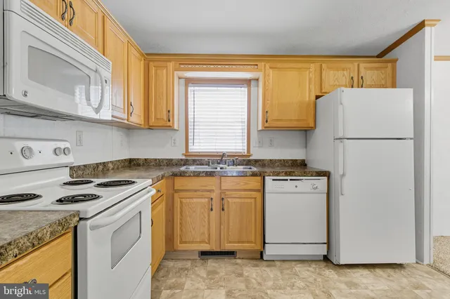 a kitchen with a stove a sink and a refrigerator
