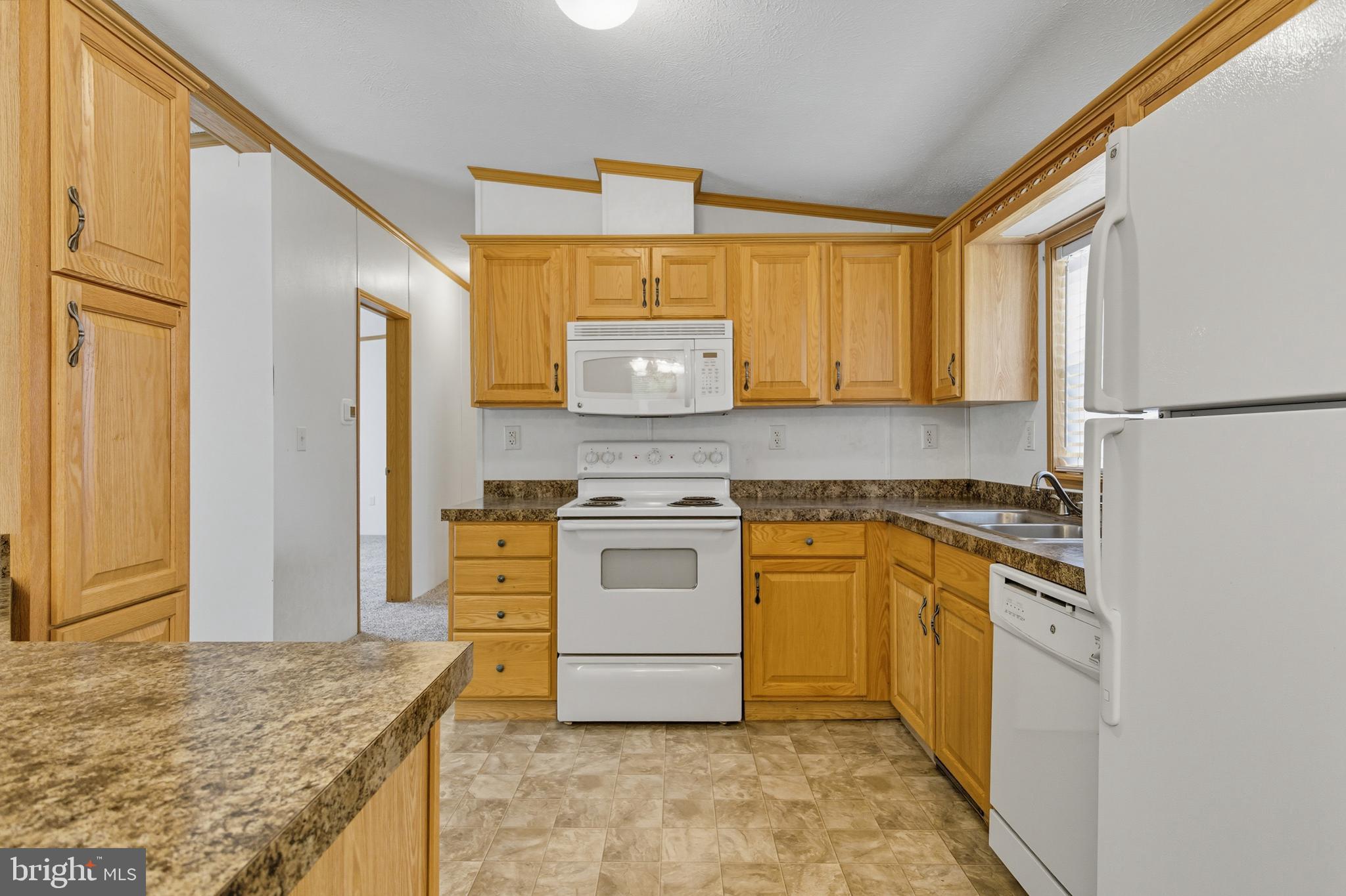 800 York Road, Unit 290 Dover, PA 17315 - Photo 10 of 23 a kitchen with stainless steel appliances granite countertop a stove a sink and a refrigerator