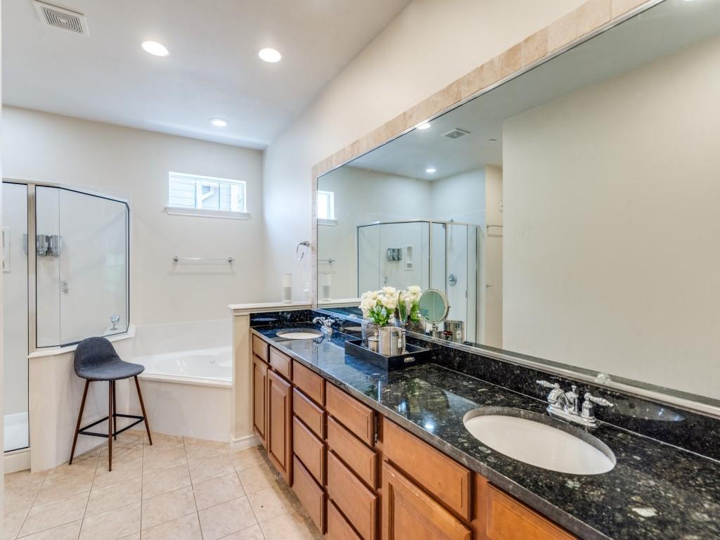 15711 Spectrum Drive, Unit 80 Addison, TX 75001 - Photo 19 of 26 a bathroom with a granite countertop sink a toilet and a mirror