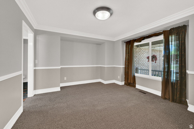 4792 Glasmann Way South Ogden, UT 84403 - Photo 29 of 70 Carpeted room featuring a large window with white trim, two-tone painted walls, white crown molding, and a flush-mount ceiling light fixture