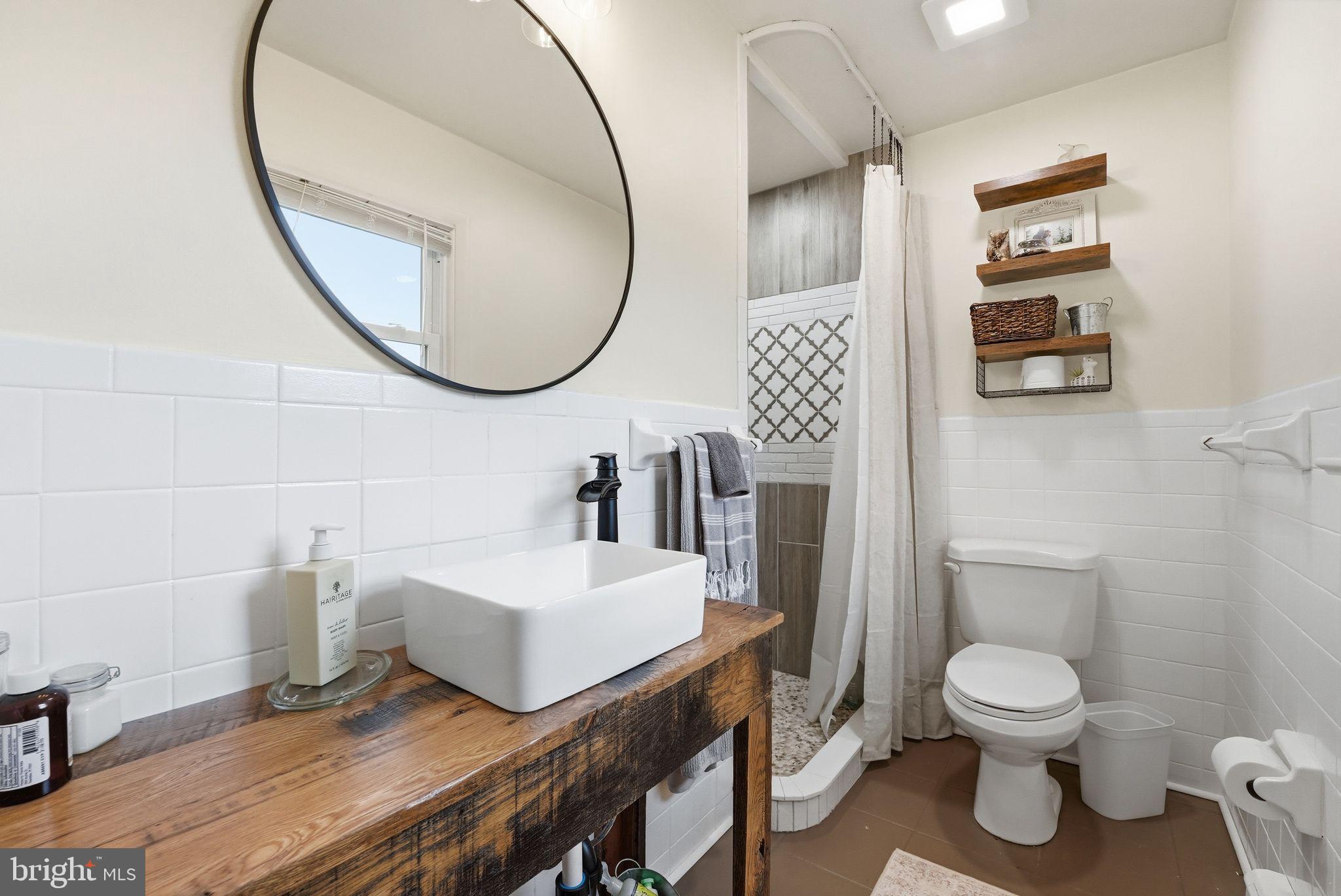 481 James City Road Leon, VA 22725 - Photo 28 of 89 a bathroom with a toilet a sink and a mirror