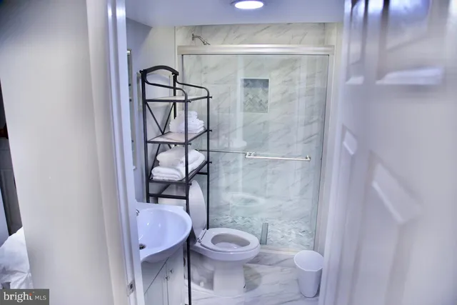 a bathroom with a toilet and a shower