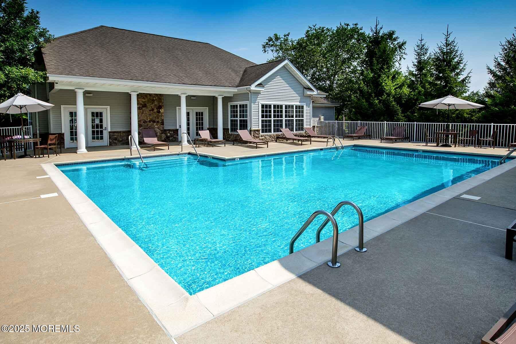 435 Timber Ridge Court Neptune Township, NJ 07753 - Photo 21 of 26 a view of a house with pool and chairs