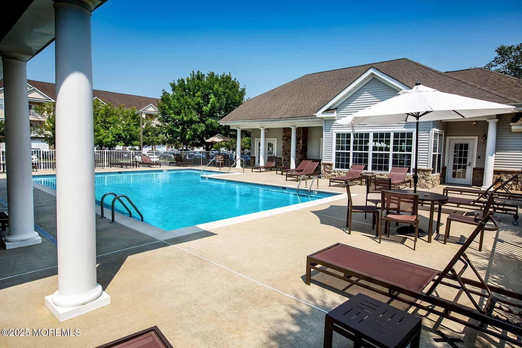 435 Timber Ridge Court Neptune Township, NJ 07753 - Photo 22 of 26 a view of a swimming pool with chairs