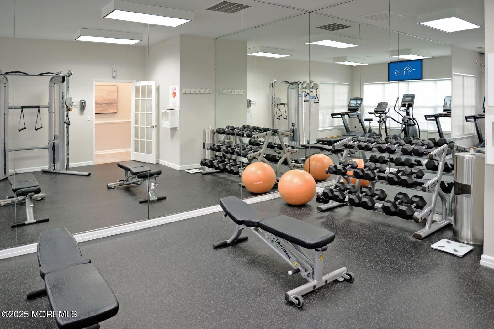 435 Timber Ridge Court Neptune Township, NJ 07753 - Photo 7 of 26 a room with gym equipment and large mirror