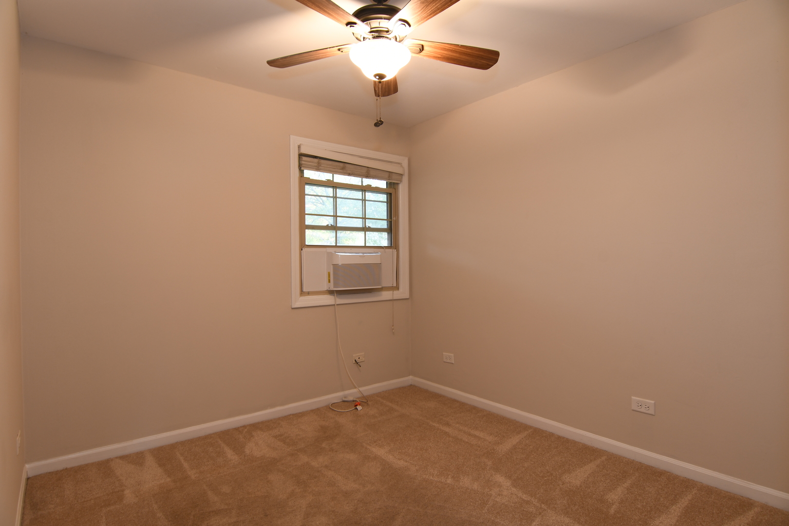 909 Warrenville Road Wheaton, IL 60189 - Photo 12 of 22 an empty room with a window and a fan