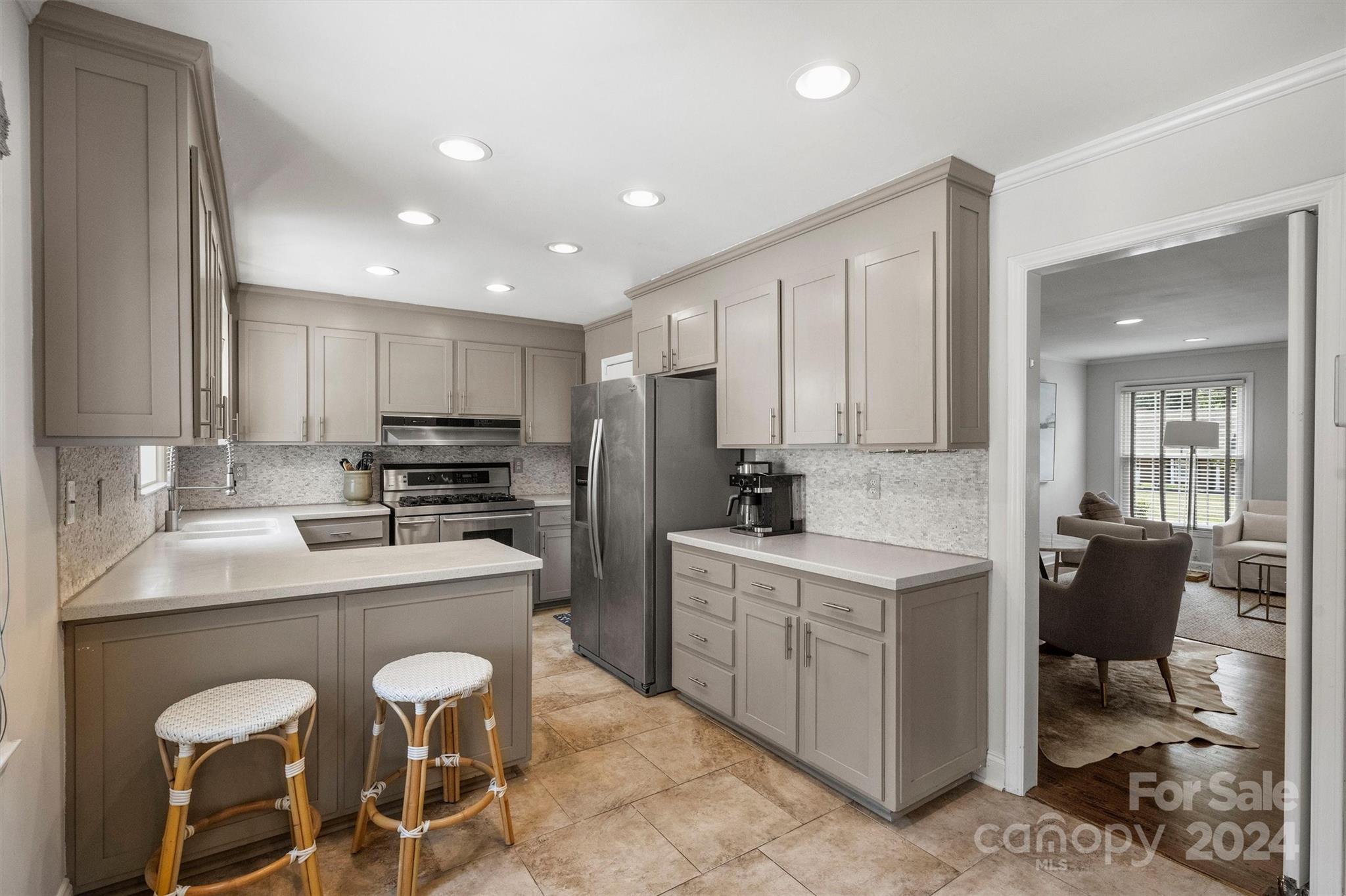 4115 Sulkirk Road Charlotte, NC 28210 - Photo 12 of 39 a kitchen with appliances a sink and cabinets