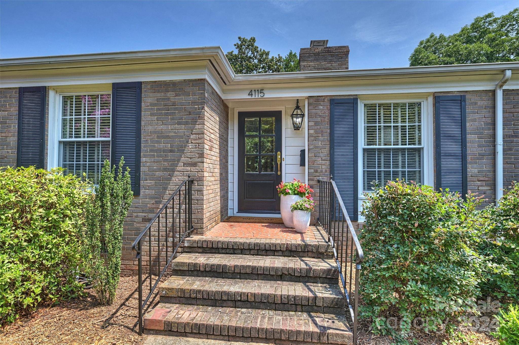 4115 Sulkirk Road Charlotte, NC 28210 - Photo 3 of 39 a front view of a house with a garden